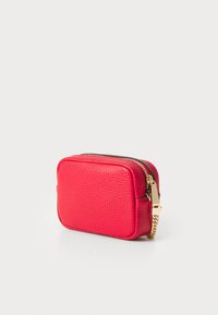Red leather bag with a textured surface, rectangular shape, gold zipper, and chain accent. Compact design suitable for small essentials.