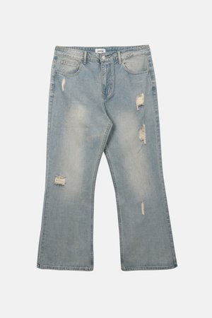 Helerohelised teksapüksid laiade säärtega, tuhmistunud aladega ja mitmete teadlikult tehtud rebenditega esi-reites ja põlvedel.