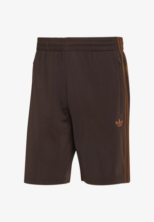 Brązowe krótkie spodenki sportowe z elastycznym pasem, kieszenią boczną na suwak, logo Adidas oraz trzema brązowymi paskami po bokach.