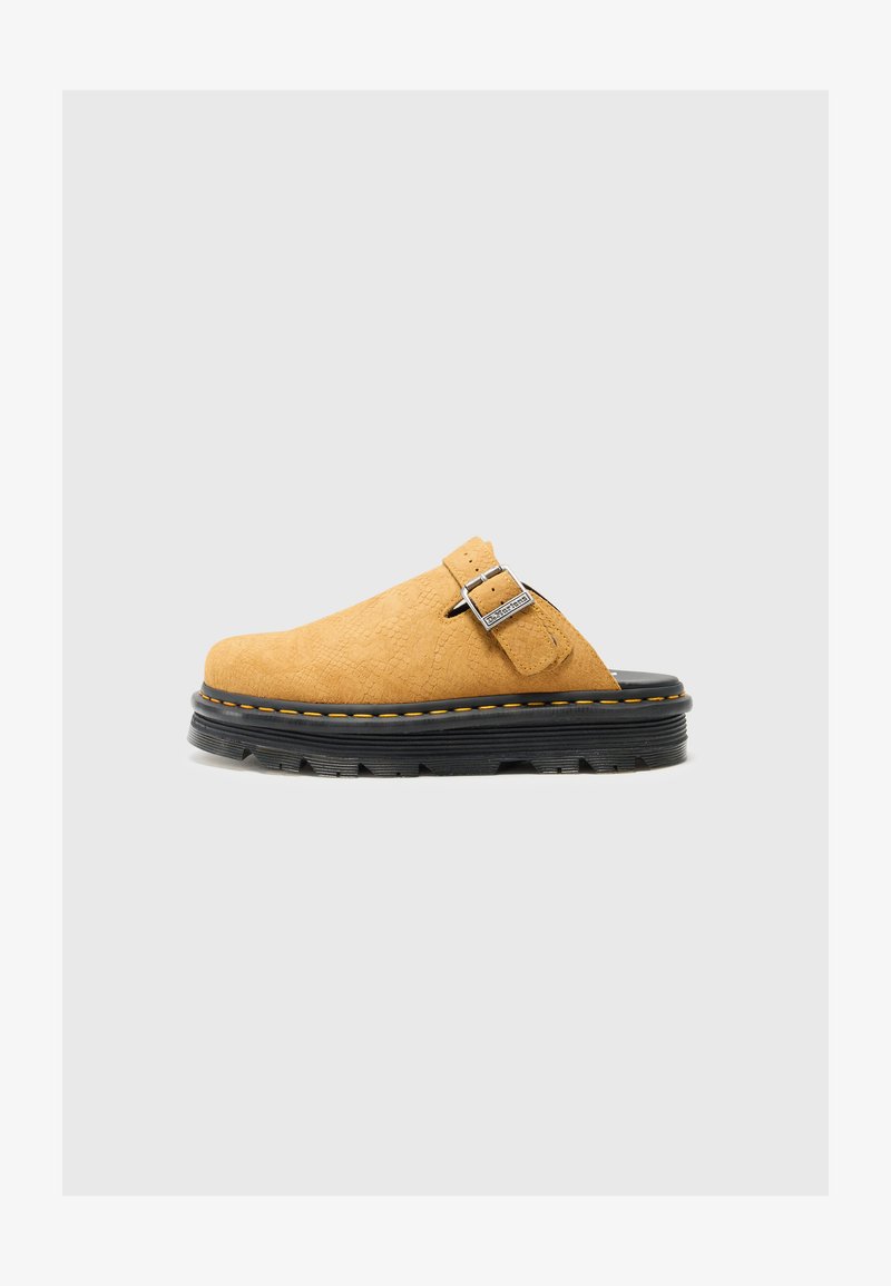Yellow suede clog with a textured finish, featuring a silver buckle and black rubber sole with yellow stitching, providing a durable design.
