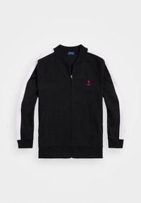 Černá mikina na zip s bílými panely na ramenou, žebrovanými manžetami a límcem. Na levé straně hrudi je malý červený logo.