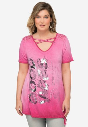 Roze T-shirt met een diepe V-hals en crisscross-details, glinsterende grafische print en korte mouwen met een gestrikt zoom. Zachte stofstructuur.