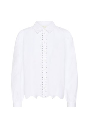 Blouse blanche à manches longues avec col pointu, devant boutonné agrémenté de deux rangées verticales de petits clous métalliques, et ourlet festonné.