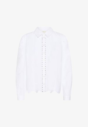 Blouse blanche à manches longues avec col pointu, devant boutonné agrémenté de deux rangées verticales de petits clous métalliques, et ourlet festonné.