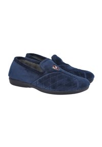 Zapatillas de color azul marino hechas de tela de felpa, con un diseño acolchado en la parte superior y una suela de goma negra. Logo bordado en la parte frontal.