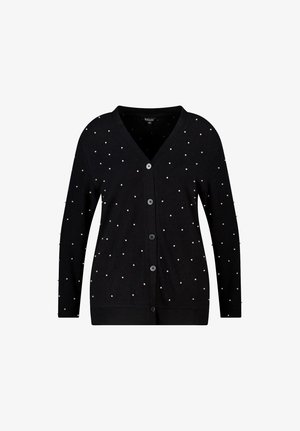 Cardigan noir à col en V, orné de perles blanches dispersées sur le tissu. Confectionné dans un matériau doux, fermeture à boutons.