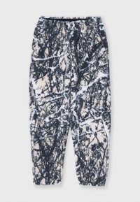 Fleece pants in a black and white forest pattern, featuring an elastic waistband, side pockets, and a tapered fit at the ankles.