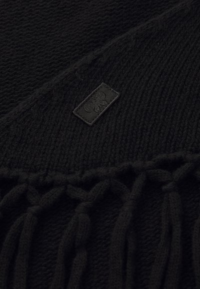 Écharpe en tricot noir avec un design texturé, dotée d'une petite patte logo et de franges aux extrémités pour un détail supplémentaire.