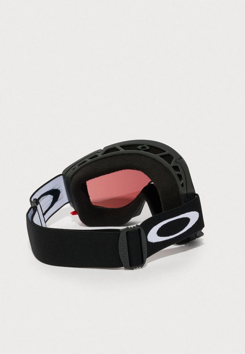 Gafas de esquí negras con un marco flexible, lentes rosas y un acolchado interior suave. La correa ajustable presenta un detalle de logo en blanco.