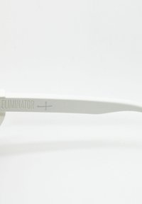 White sunglasses with a minimalist design. Features a smooth finish, flat lenses, and "ELIMINATOR" text embossed on the temple.