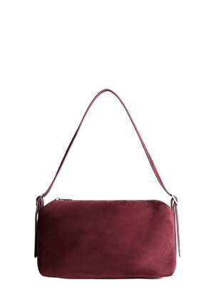 Burgundy suede handbag with a smooth texture, zip closure, and a single shoulder strap, featuring sleek, rounded edges and minimal hardware.