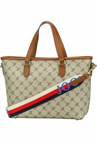 Beige kangaskassi, jossa on ruskeita nahkakoristeita, esittää toisiinsa kytkeytyvää kuvioita ja monivärisen olkahihnan.