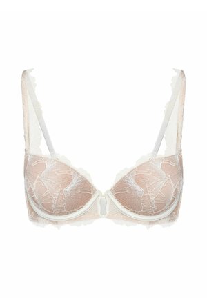 Półprzezroczysty beżowy biustonosz z białą koronką w kwiatowy wzór, miseczkami na fiszbinach i regulowanymi ramiączkami na białym tle.