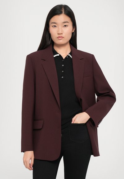 Maroon blazer with a structured design, notch lapels, and front pockets, layered over a black button-up top. Smooth fabric texture.