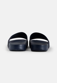 Navy blue slide sandals made of rubber with a smooth texture, featuring wide straps and a contoured footbed for comfort.