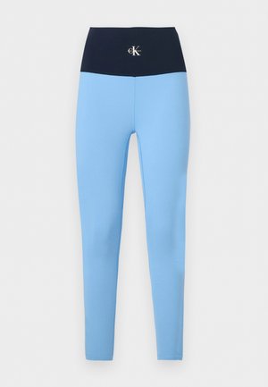 Világoskék leggings magas, széles tengerészkék derékrésszel, középen elöl egy kis fehér Calvin Klein logóval.