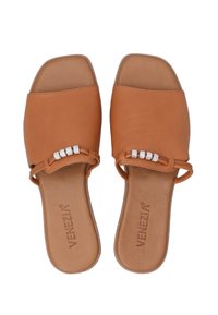 Tan leather slide sandals with a squared toe, featuring a decorative strap with three clear rhinestones. Rubber sole with logo detail.