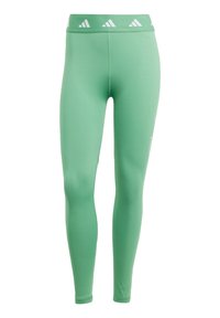 Gröna leggings med ett mjukt, stretchigt tyg. Hög midja med vita triangelaccenter. Tight passform. Lämpliga för aktiv användning.