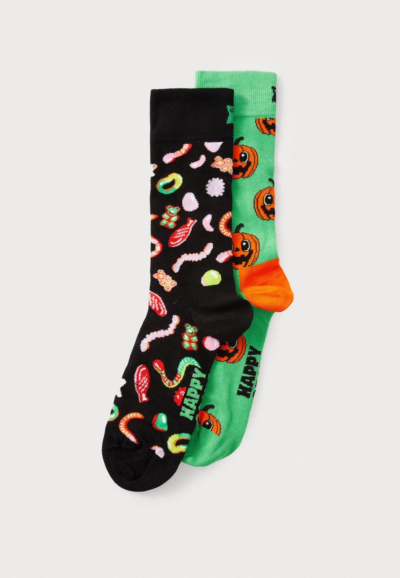 Dos pares de calcetines: uno negro con patrones de caramelos coloridos, el otro verde con calabazas naranjas y el texto "HAPPY". Material de mezcla de algodón.
