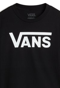 T-shirt in cotone nero con un grande logo bianco "VANS" sulla parte anteriore, in un taglio classico con collo rotondo e maniche corte.
