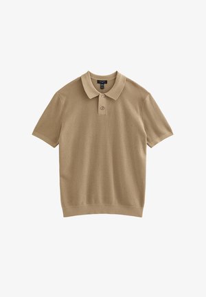 Polo à manches courtes beige en tissu côtelé. Il présente un col à revers, une patte à deux boutons et un ourlet droit.