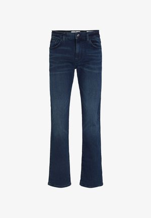 Ciemnoniebieskie dżinsy o slim fit, z pięcioma kieszeniami, zapinane na zamek błyskawiczny i guzik. W połączeniu z białymi trampkami.