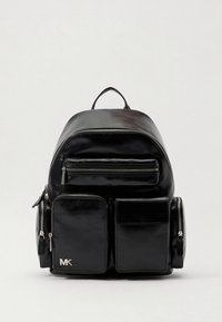 Black leather backpack with multiple zippered pockets, smooth texture, rounded top, and a prominent logo on the front.