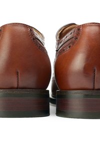 Brown leather shoes with a smooth finish, detailed brogue design, rounded toe, and a stacked wooden heel with a dark accent.
