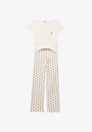 Top bianco a maniche corte con bottoni e piccola toppa con orsetto abbinato a pantaloni larghi coordinati con stampa orsetti.
