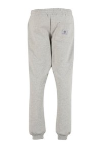 Graue Jogginghosen mit elastischem Bund, gerippten Knöcheln und einer einzelnen Hintertasche mit einem rechteckigen Logo-Patch.