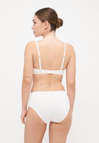White cotton bra and underwear set. Simple design with adjustable straps and minimal stitching. Soft texture, classic hipster cut.