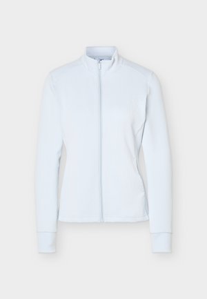 Lys blå ribbestrikket jakke med langermet, frontglidelås og høy krage, vist flatt på hvit bakgrunn.