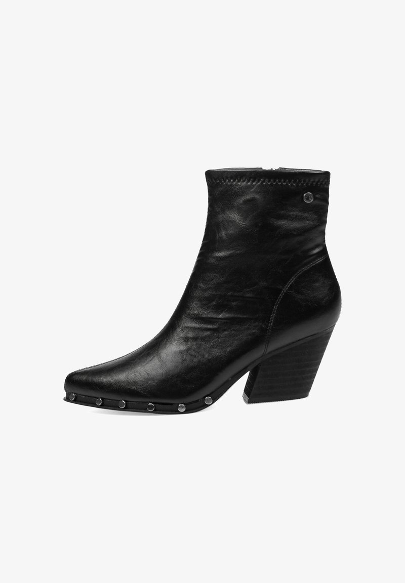 Botín de cuero negro con punta afilada, tachuelas plateadas a lo largo del borde de la suela y tacón ancho.