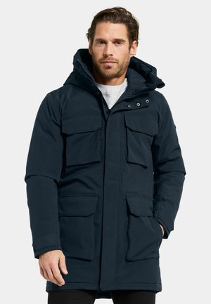 Marine parka-jas met een capuchon, voorzien van meerdere voorzakken, een ritsluiting en een gestructureerde stof die geschikt is voor koud weer.
