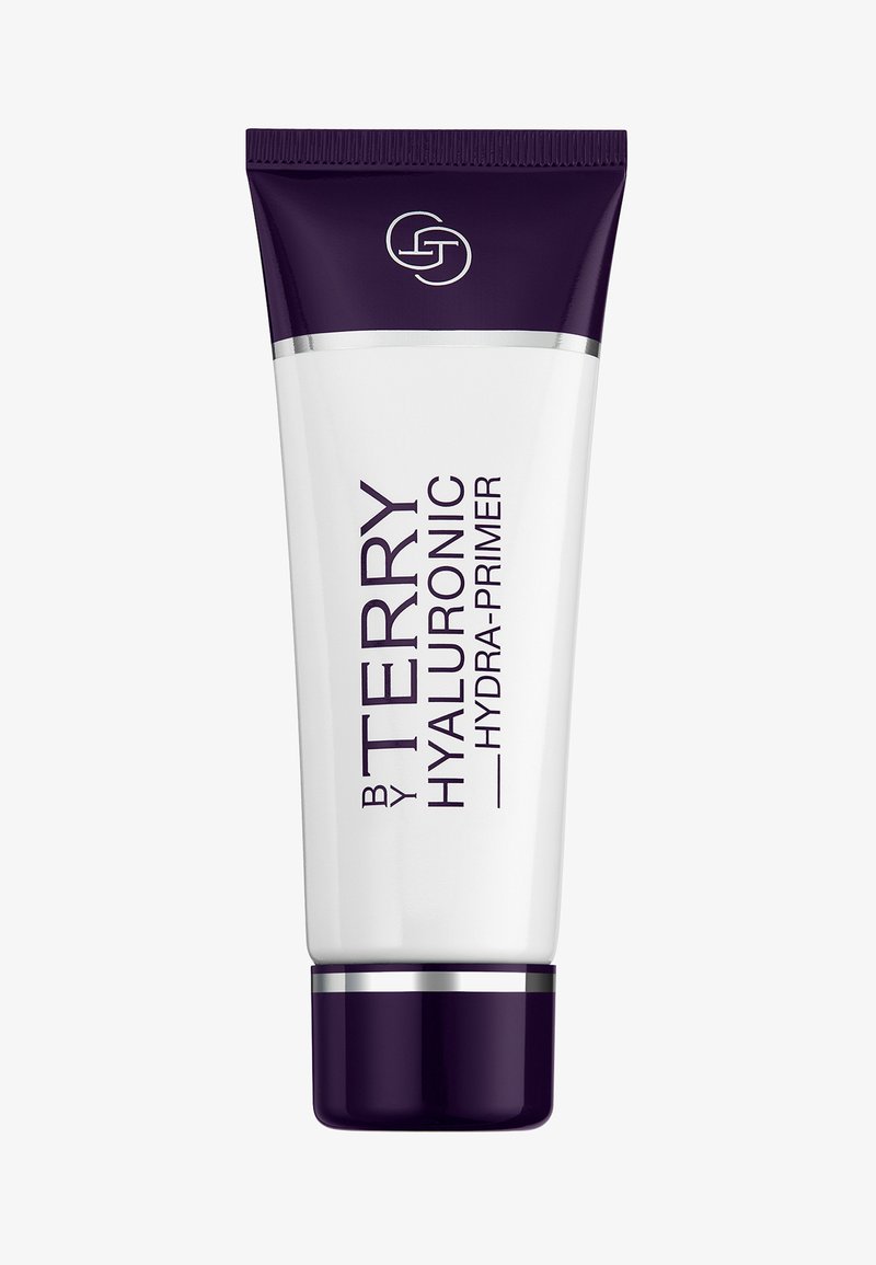 Tube en plastique blanc avec un capuchon violet, étiqueté "BY TERRY HYALURONIC HYDRA-PRIMER." Texture lisse, design épuré et branding minimaliste.