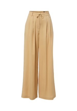 Pantalon beige à jambes larges avec plis, taille ajustable par cordon de serrage et passants de ceinture, en tissu léger.