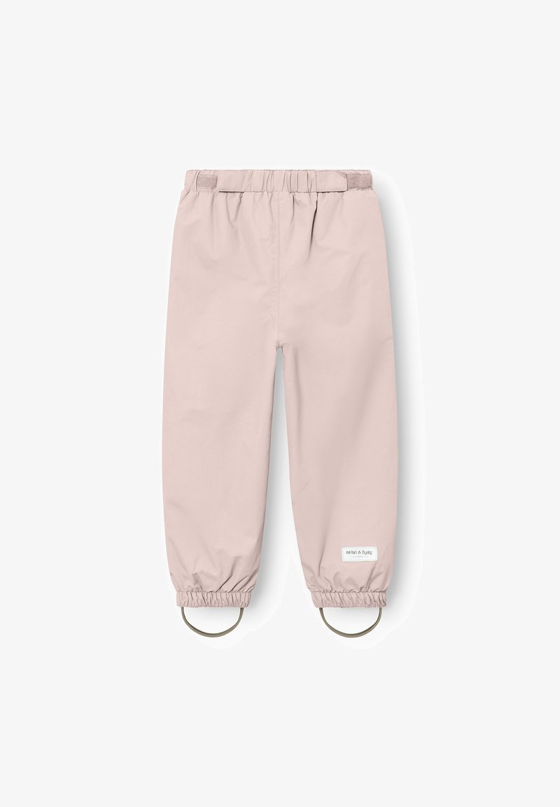 Pantalones infantiles impermeables de color rosa claro con cintura elástica, puños en los tobillos y tirantes para los pies, mostrados desde atrás.