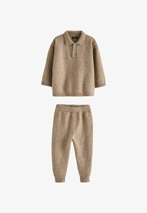 Beige knit sweater with polo collar and three buttons, paired with matching tapered pants featuring elastic waistband and ribbed cuffs.