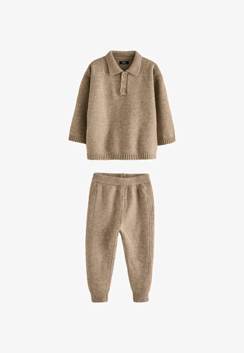 Beige knit sweater with polo collar and three buttons, paired with matching tapered pants featuring elastic waistband and ribbed cuffs.