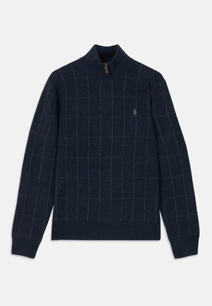 Navy sweater with a zip collar, featuring a grid pattern in light green and brown. Soft texture with ribbed cuffs and hem, logo detail on chest.