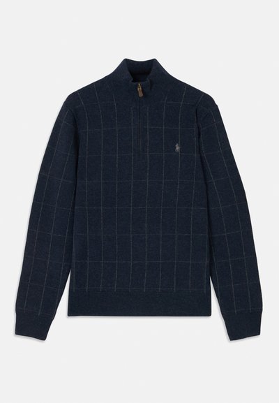 Granatowy sweter z zamkiem przy kołnierzu, z siatką wzór w jasnej zieleni i brązie. Miękka tekstura z prążkowanymi mankietami i dołem, detal z logo na piersi.