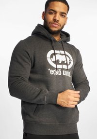 Hoodie gris avec une poche kangourou, des poignets et un ourlet côtelés, arborant un logo graphique blanc et une capuche avec cordon pour un ajustement personnalisé.