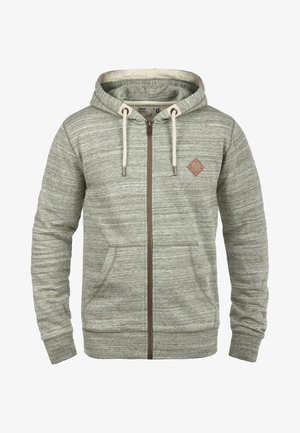 Gråstripet hettegenser med frontglidelås, to side lommer og et lite brunt lærlogo-patch på brystet. Har justerbare snorer.