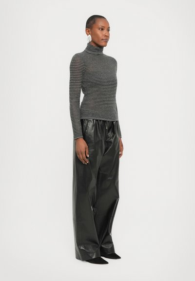 Gray striped turtleneck sweater in lightweight knit, paired with loose-fitting black leather pants. Sleek silhouette, smooth texture.