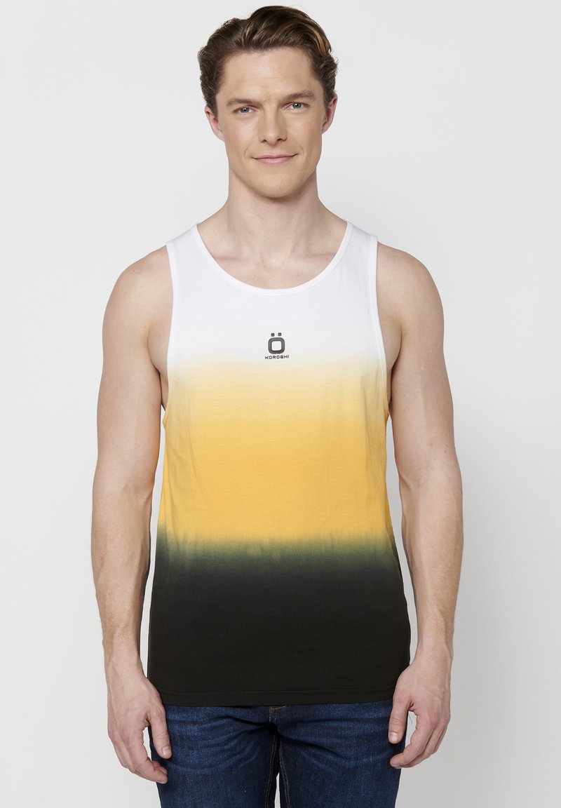 Varrukaehteta tank top puuvillast, millel on gradient valgest kollase ja mustani. Ees on väike logo, mis on keskendatud kaeluse alla.