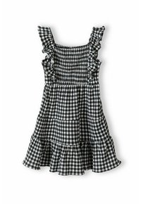 Robe en vichy noir et blanc avec des bretelles à volants, un corsage smocké et un ourlet à volants en plusieurs couches. Le tissu a une texture légère.