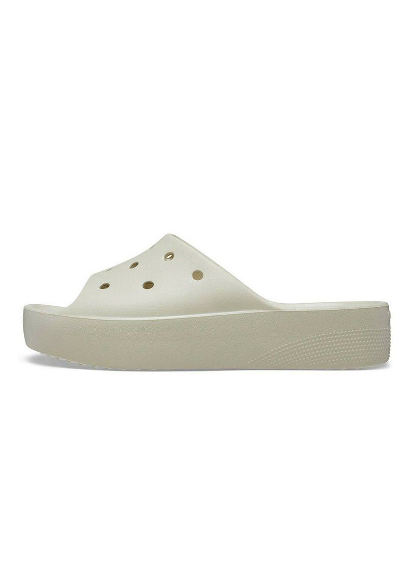 Zoccolo slip-on beige chiaro realizzato in plastica morbida, con fori di ventilazione, suola spessa e fondo testurizzato per migliorare la presa.