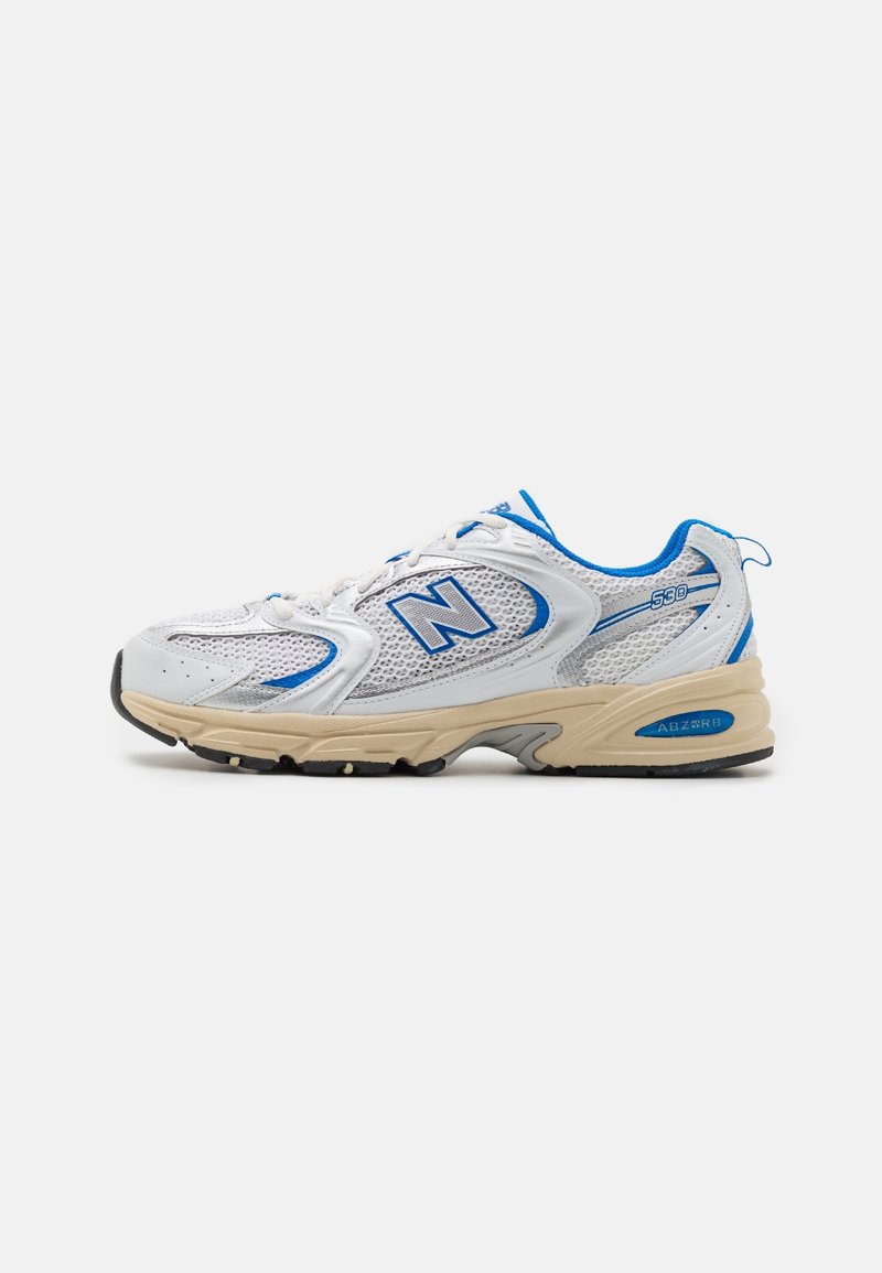 Chaussure de running New Balance 530 blanche et bleue avec semelle beige et détails en tissu mesh, vue de profil sur un fond uni.