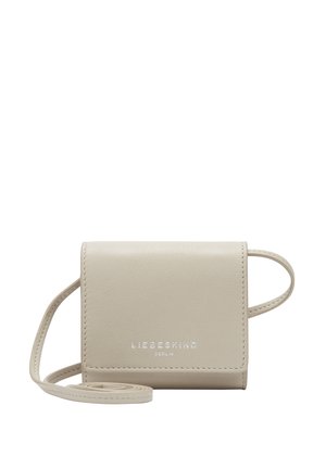 Beige leather crossbody bag with a rectangular shape, embossed logo, and a thin strap. Smooth texture and minimalist design.