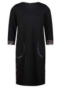 Vestito nero con maniche a tre quarti, caratterizzato da dettagli con stampa leopardata sui polsini e sui lati, e due ampie tasche applicate.